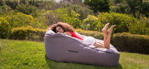 Young lady lounging on a Carefree Grey Twin Satellite Sofa from Ambient Lounge in New Zealand