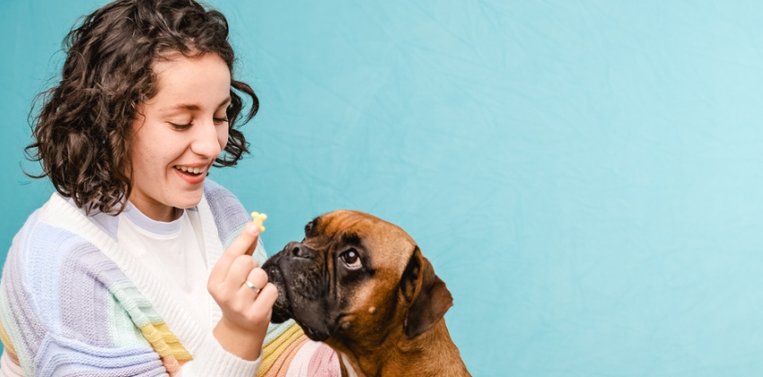 lady showing the dog treat