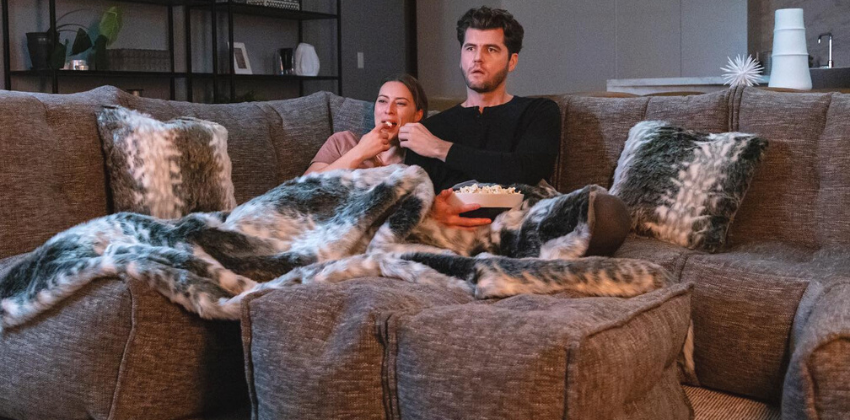 couple watching and chilling on an ambient lounge modular sofa