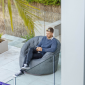 Man sitting on a titanium weave butterfly sofa bean bag from ambient lounge in New Zealand