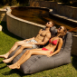 couple lounging on a titanium weave twin avatar lounger from ambient lounge in new zealand
