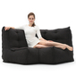 Modular bean bag corner in Black Sapphire with model lounging