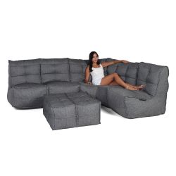 Woman lounging on a Mod5 titanium weave lounge set from Ambient lounge in New Zealand